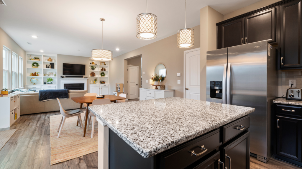 Modern pendant lights in bright remodeled kitchen highlight raised home value through budget friendly improvements